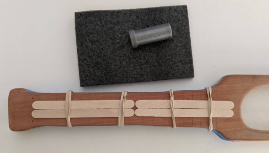 Rubber bands and popsicle sticks in place