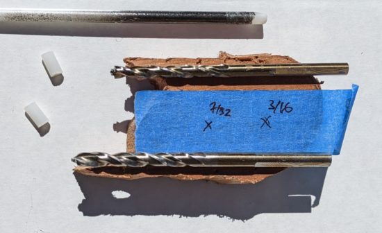 Testing two different sizes of drill bits for fitting with the pieces of plastic rod