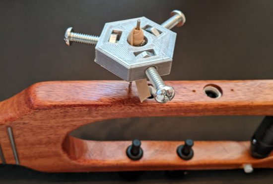 Drill bit wrapped in an old rubber band before securing in the hand drill