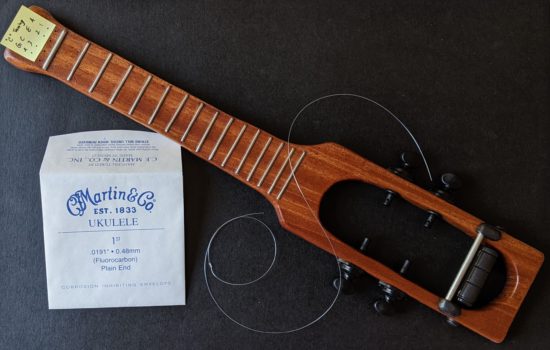 One string, a double knot tied about an inch and a half away from one end, then a second knot, with the excess string fed back through the hole