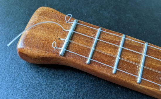I was able to feed some of the strings back down into the string hole