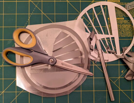 Design cut out, excess vinyl removed from sticky clear plastic backing, and cut out