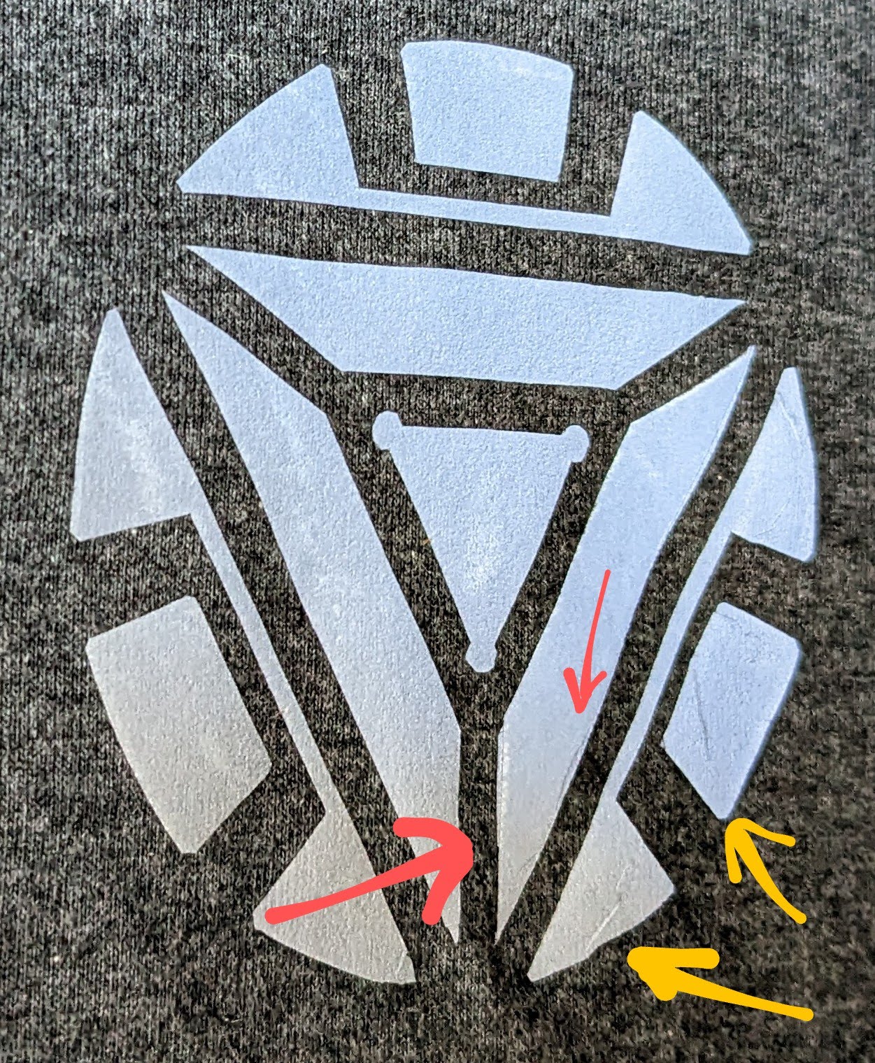 Yellow arrows show where the design pulled up and wrinkled slightly. The red arrows point to where the design tore and was repaired.